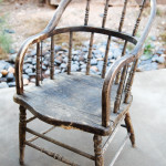 Rustic Armchair's black finish is weathered and charming